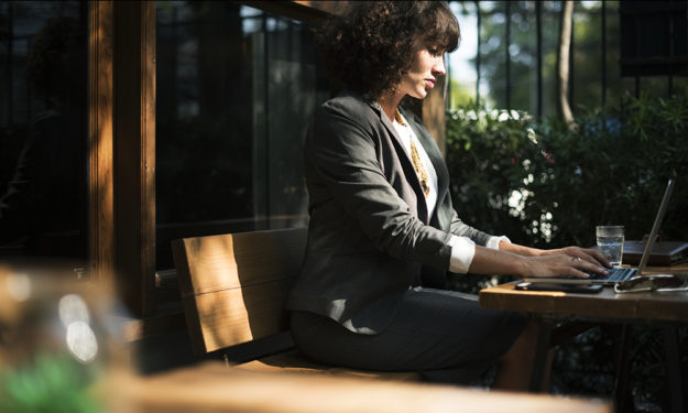 Woman working with laptop at coffee shop